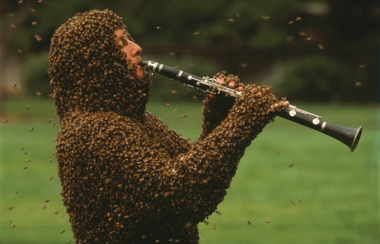 playing a clarinet covered in bees